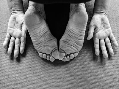 Close-up of feet on a yoga mat, showing focus on a stable stance.
